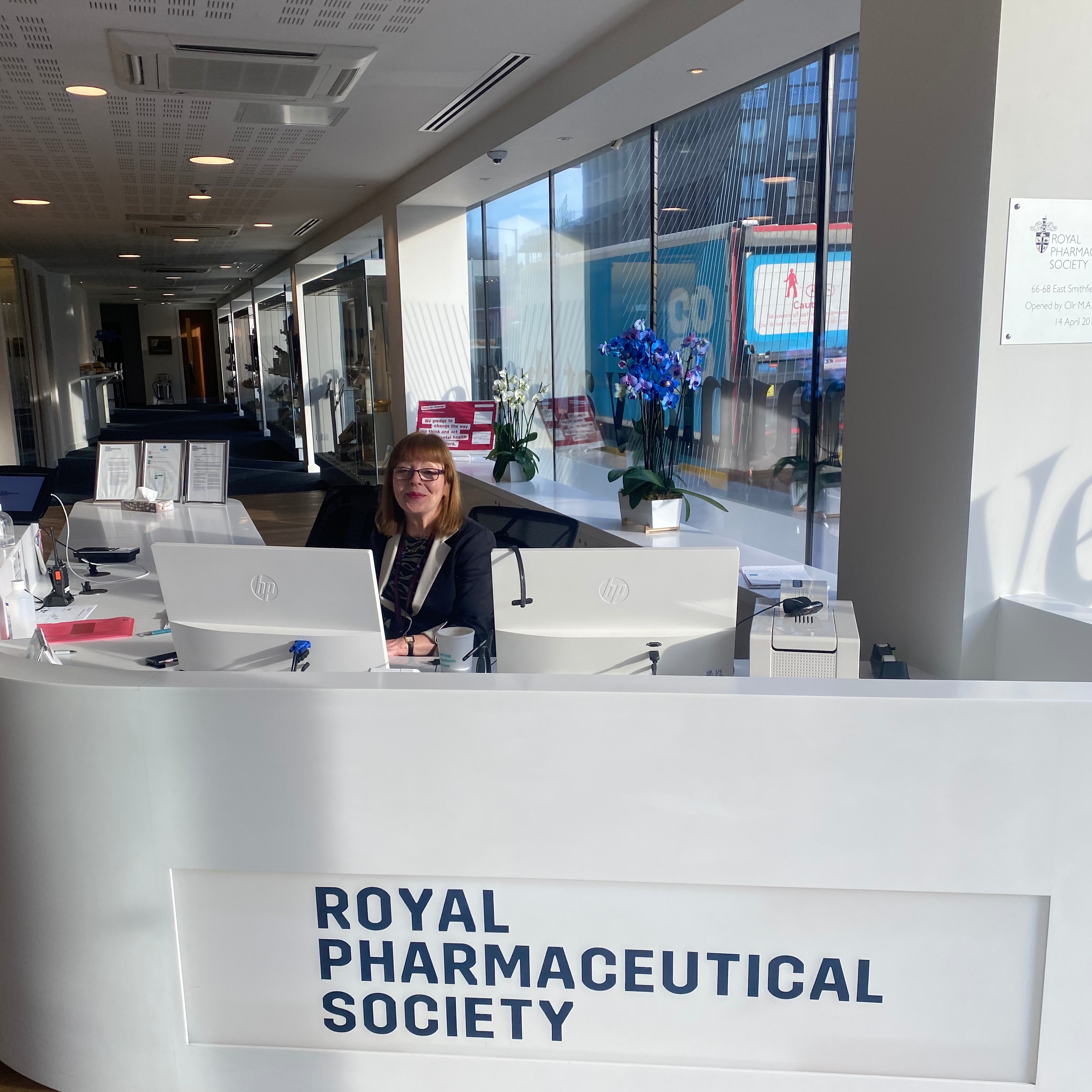 Receptionist Alice sat at the white front desk